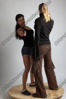 2021 01 OXANA AND XENIA STANDING POSE WITH GUNS 2…
